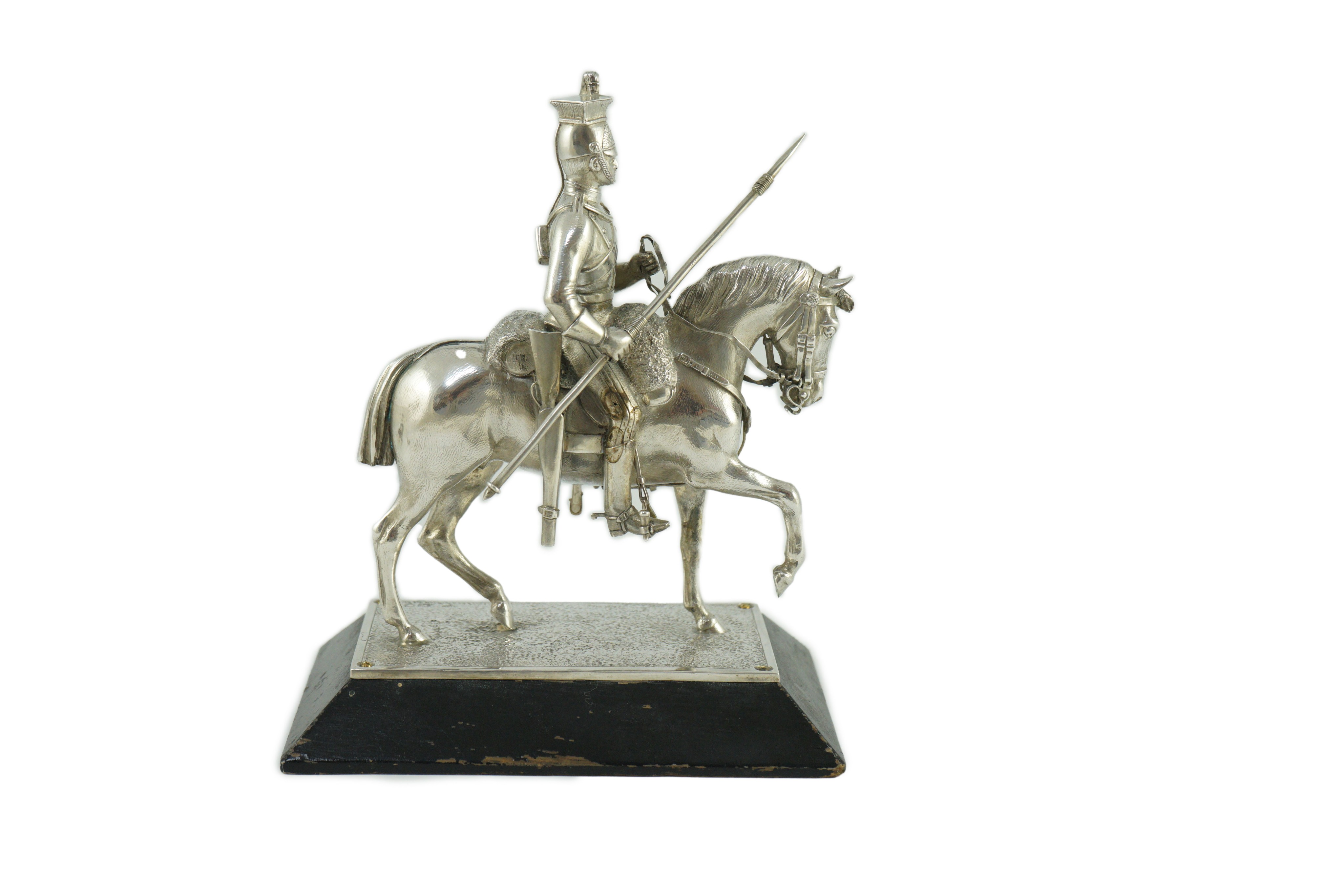 An early 20th century miniature model of a Royal Lancer on horseback, by The Goldsmiths and Silversmiths Co Ltd